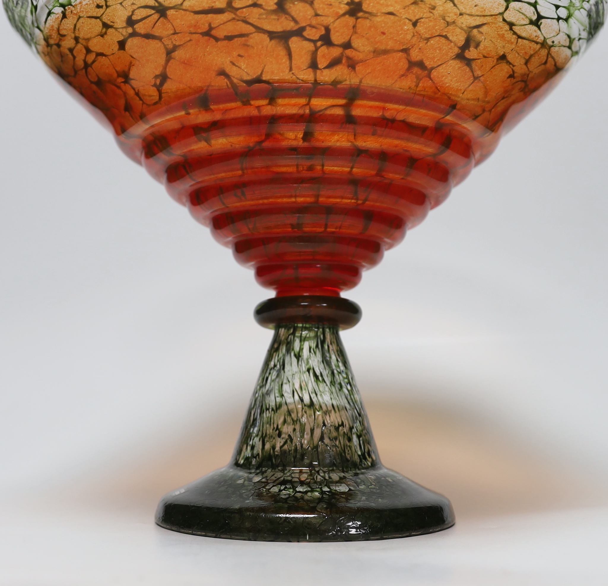 A Kosta Boda orange and green glass pedestal bowl, signed KOSTA BODA / K. ENGMAN 7050647, 26cm high